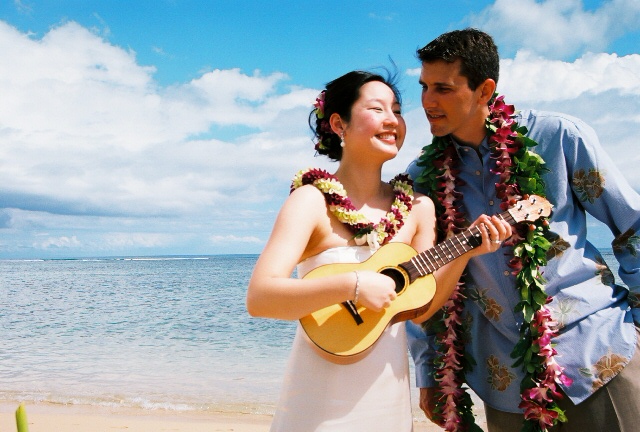 bride playing the ukulele for her groom in Hawaii